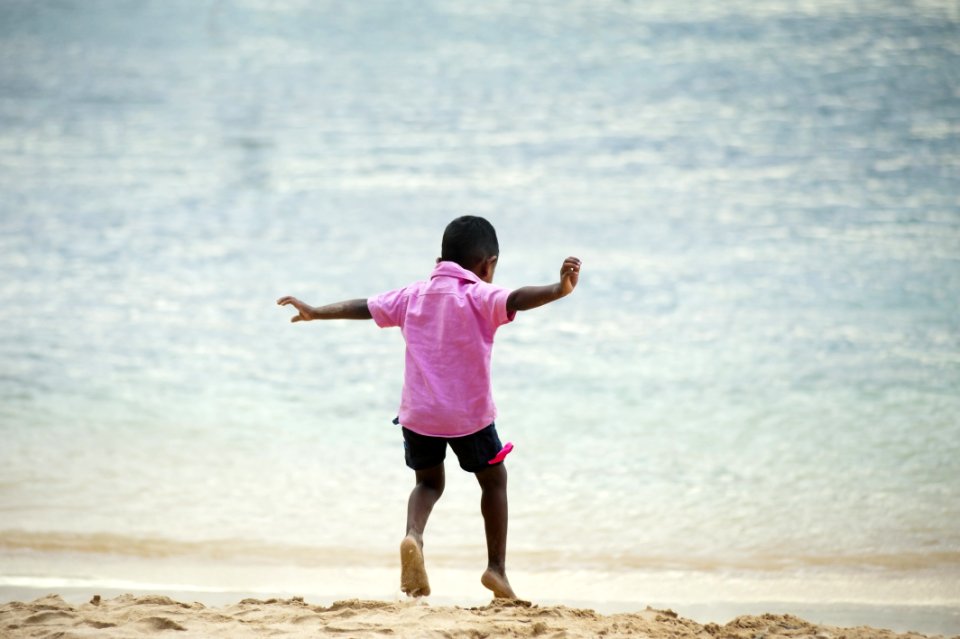 Boy Playing At The Beach
