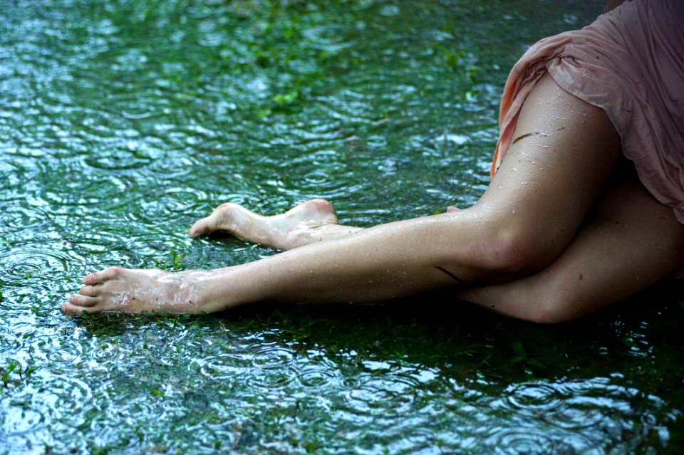 Womans Hips And Legs Lying In Green Mud
