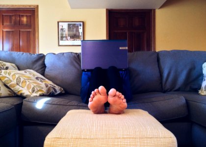 Person On Sofa With Laptop