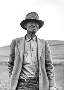 Grayscale Portrait Of A Man In Suit Jacket And Panama Hat photo