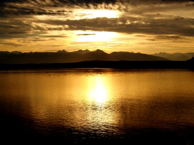 Calm Sea Near Mountain At Sunset photo