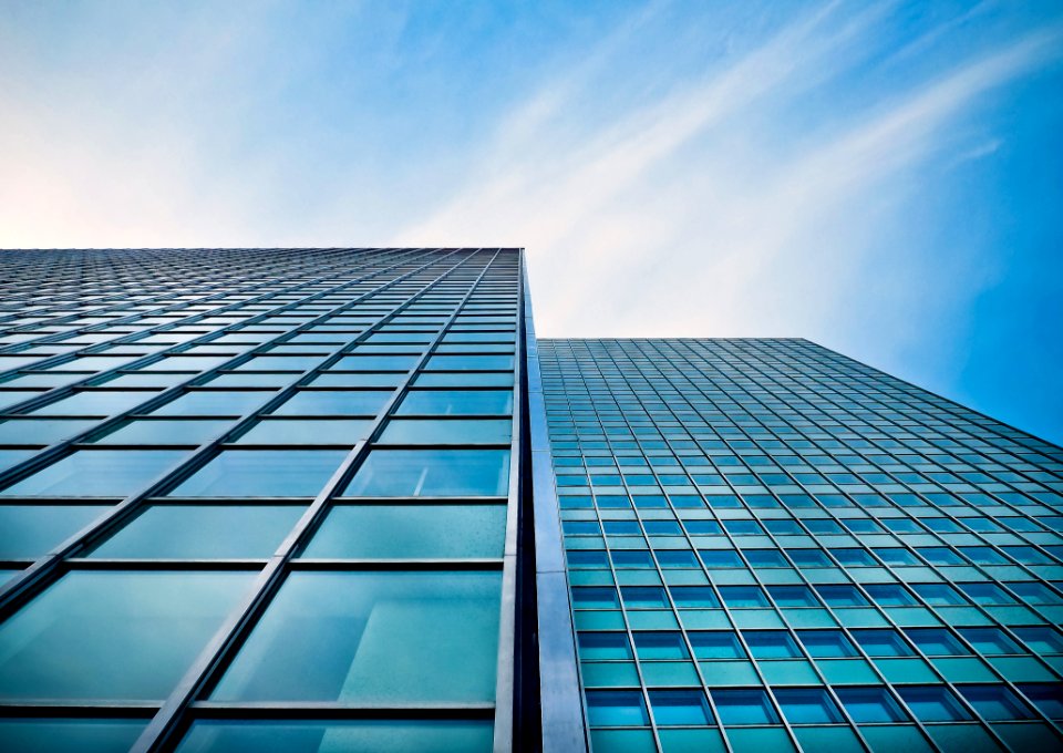 Low Angle View Of Office Building Against Blue Sky