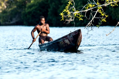 Man In Black Shorts Riding Rowboat During Daytime photo