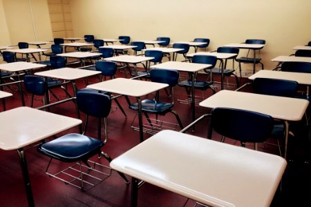 Student Desks And Chairs In Classroom