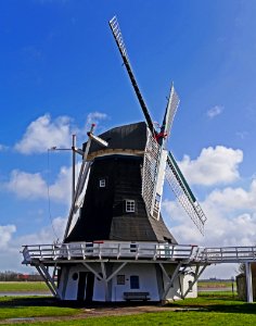 White And Black Wooden Windmill During Daytime