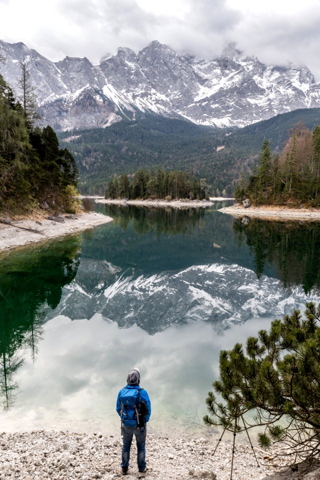 Hiker On Banks Of Alpine Lake