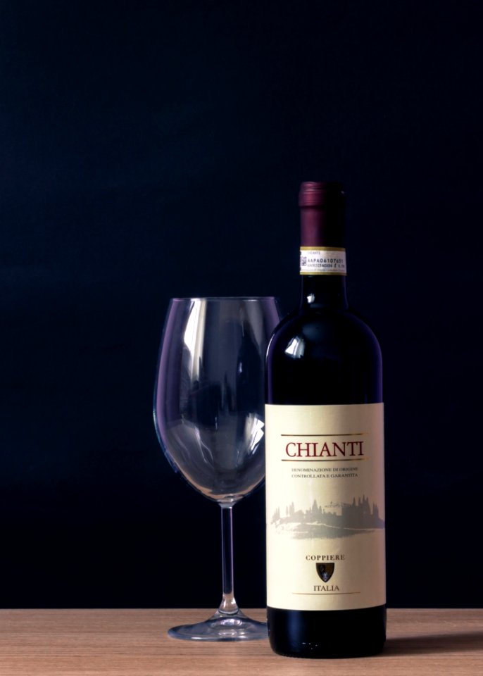 Chianti Labeled Bottle And Clear Long Stem Glass On Table photo