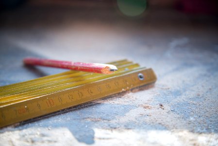 Red Pencil On Gold Metal Rulers
