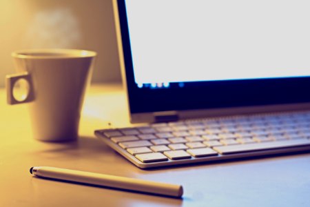 Computer And Coffee On Desktop