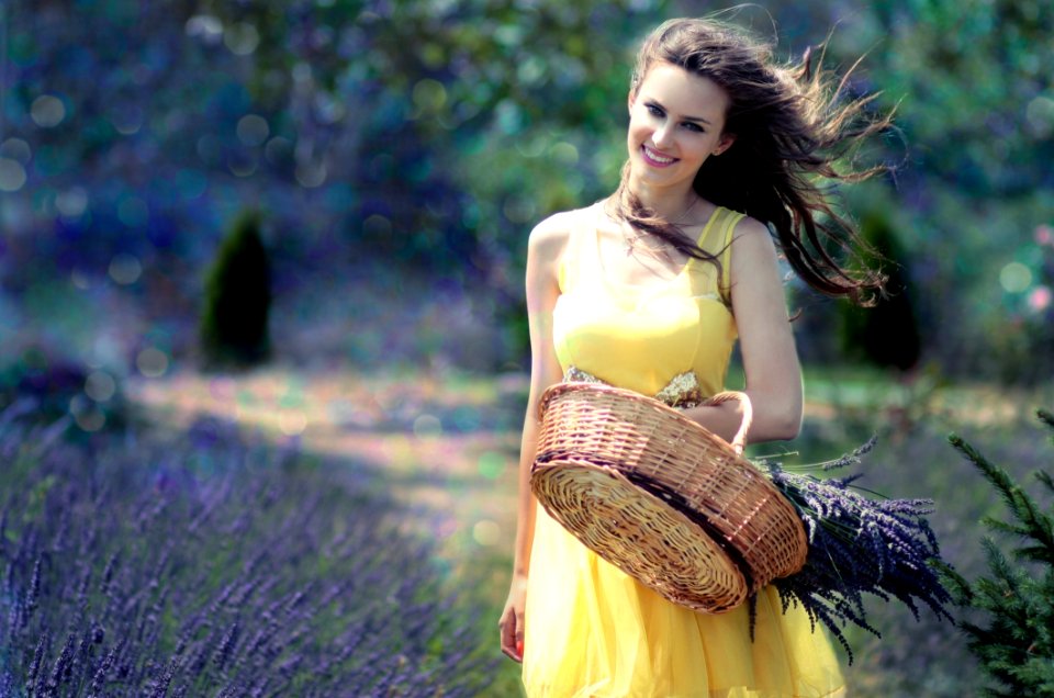 Woman In Yellow Maxi Dress Holding Brown Woven Picnic Basket Walking During Daytime