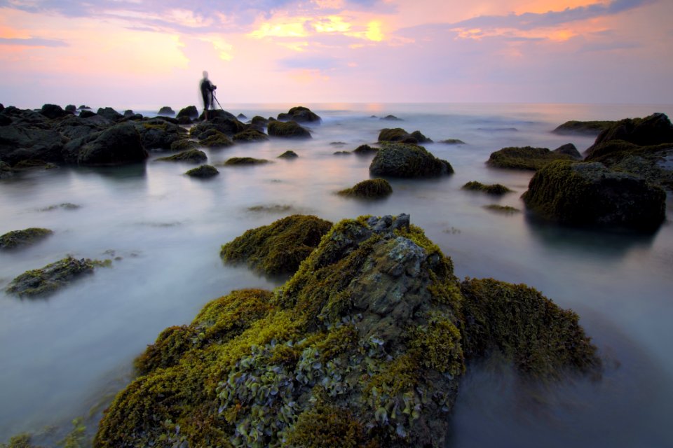 Blur Of Water On Rocks At Sunset