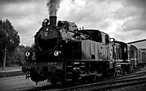 Train On Railroad Tracks Against Sky photo