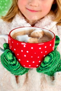 Girl In White Snow Coat Holding Red And White Ceramic Mug photo