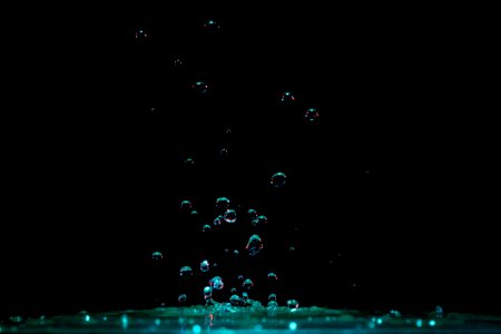 Close-up Of Water Splashing Against Black Background photo