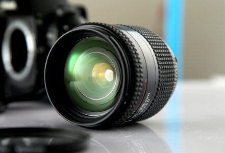 Black Camera Lens On White Sureface photo