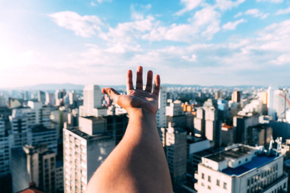 Hand In Front Of Cityscape