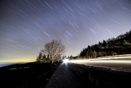 Star Trails Over Country Roadway At Sunset photo