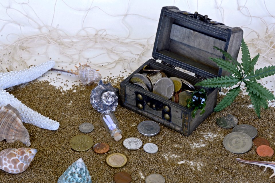 Treasure Chest On Beach And Coins Beside It