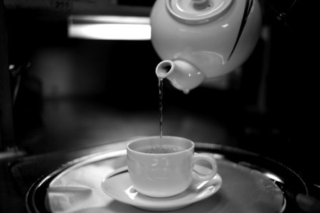 Timelapse Photography Of Water Pouring From White Ceramic Teapot To White Ceramic Mug On White Saucer photo