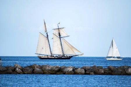 Sailboats Behind Rocky Causeway photo