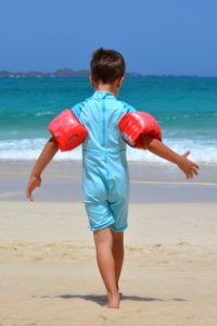 Boy On Blue Onesie On Beach During Day