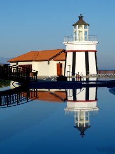Lighthouse Reflecting In Blue Waters