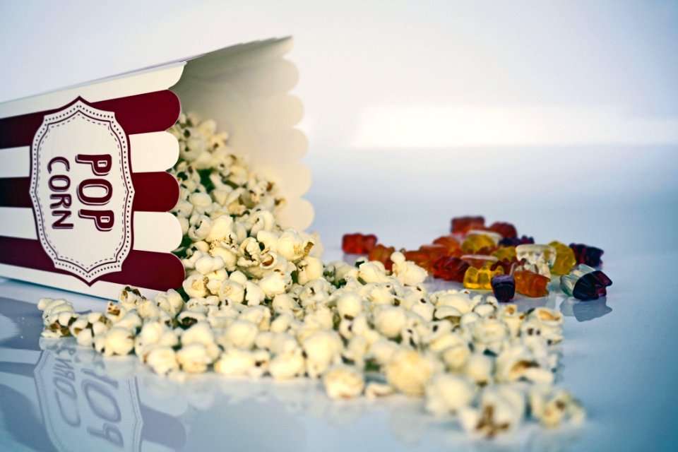 White And Green Pop Corns Beside Red Gummy Bear