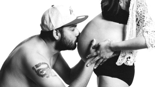 Man Kissing Womans Belly photo