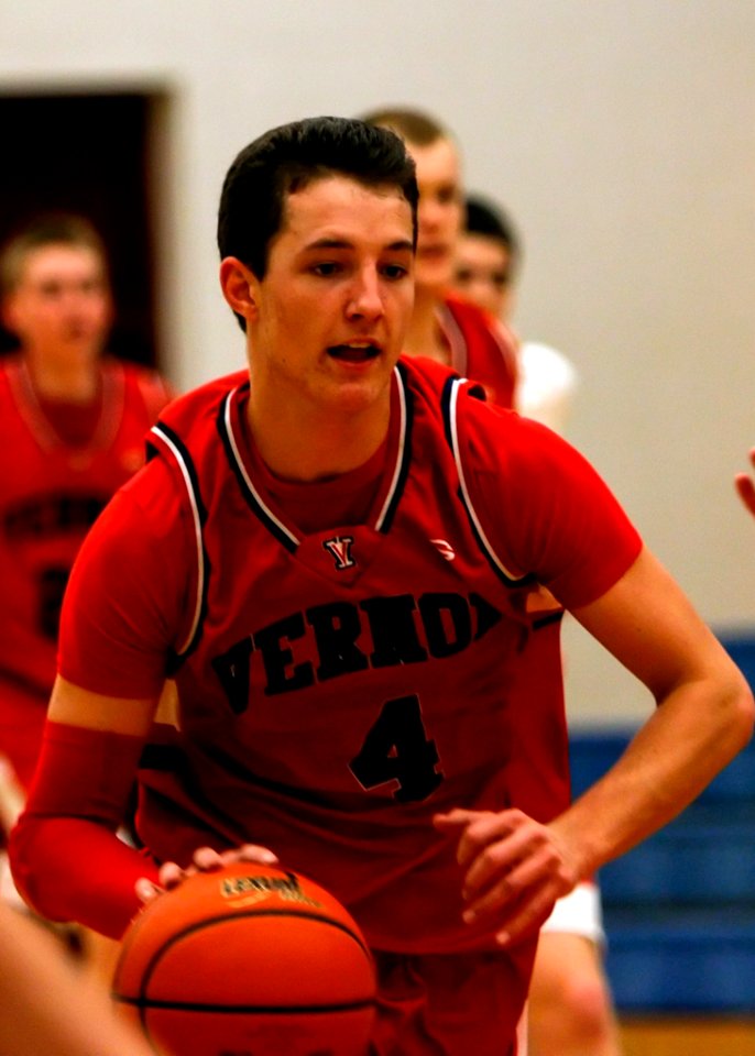 Man With Vernoa 4 Basketball Jersey Holding The Basketball