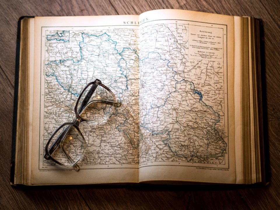 Black Framed Eyeglasses Map In Book photo