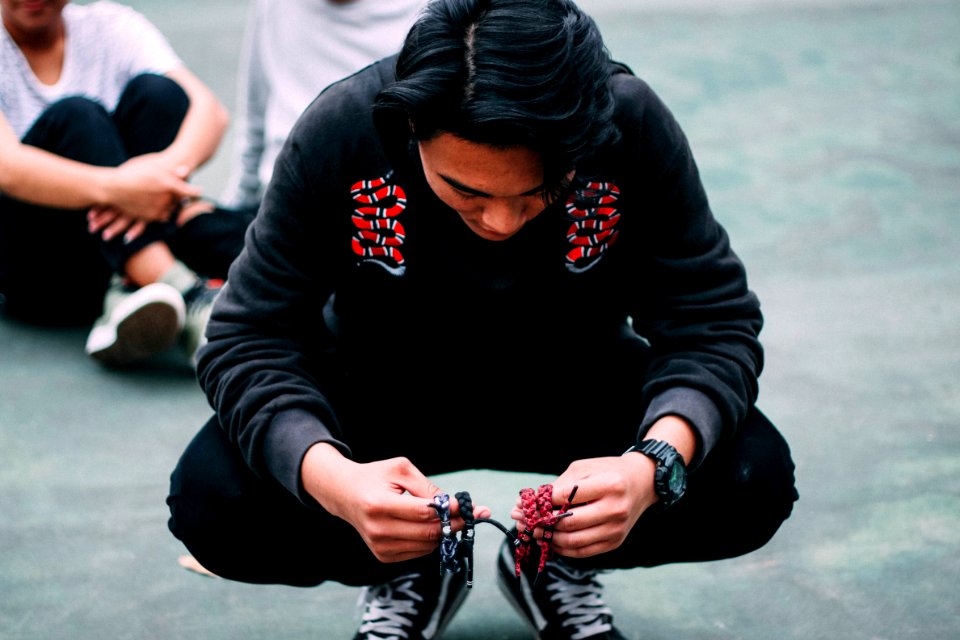 Portrait Of Man Squatting On Streets