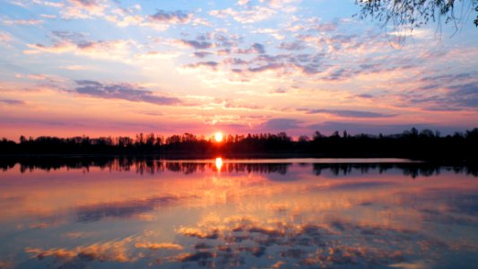 Sun Set Reflecting In Calm Lake photo