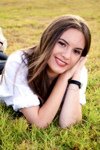 Portrait Of Young Woman Lying On Grass photo