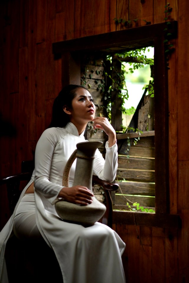 Woman Wearing Traditional Clothes Holding A Jar