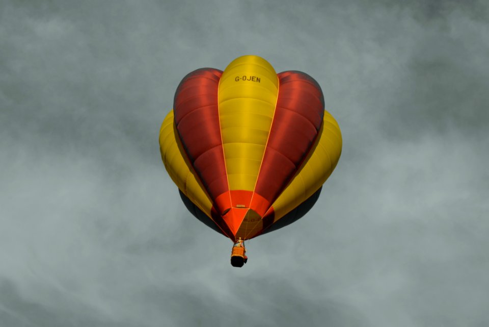 Red And Yellow Hot Air Balloon Under Sea Of Clouds