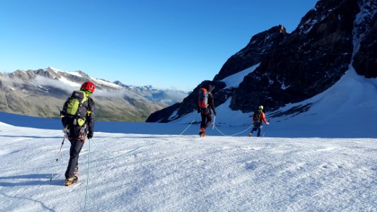 Man Walking On Snow Covered Mountain