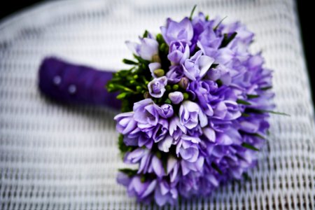 Purple Flower Bouquet On White Woven Chair
