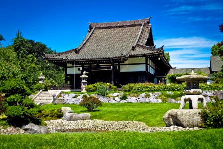 White And Black Temple Surrounded By Green Grass Field During Daytime photo