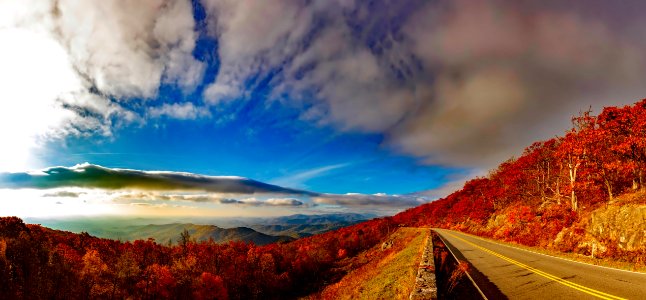 Scenic View Of Mountain Road Against Cloudy Sky