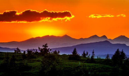 Scenic View Of Mountains Against Sky At Sunset photo