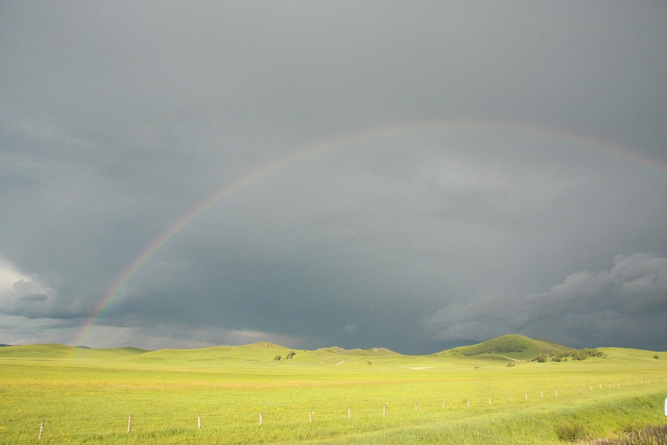 Prairie rainbow rain cloudy day