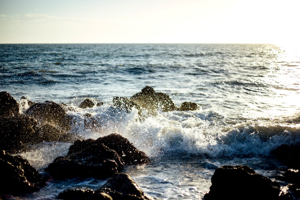 Photo Of Blue Ocean Wave Coming To The Rocky Shore