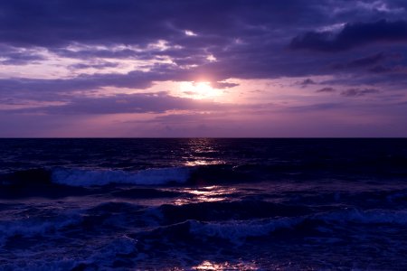 Photo Of Blue Ocean And Dark Clouds During Sunset photo
