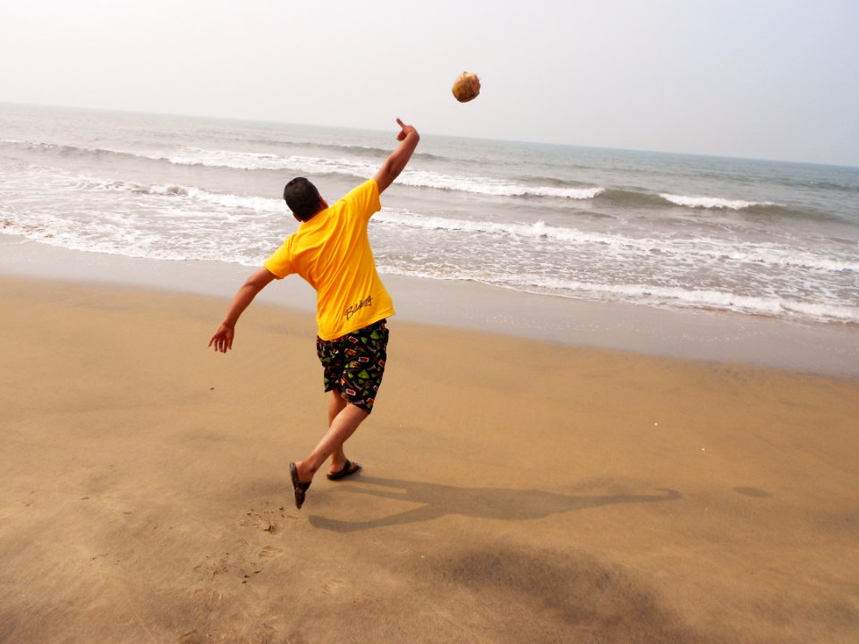 Guy Throwing Coconut In Sea