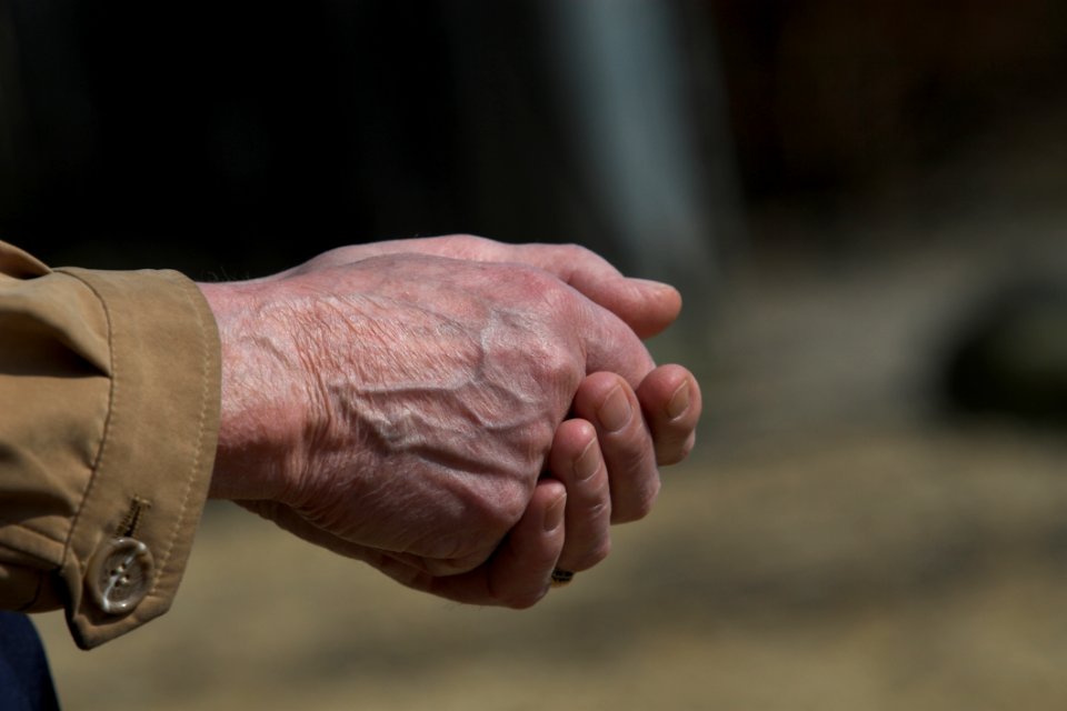 Man In Brown Dress Shirt Clasp Both Hands