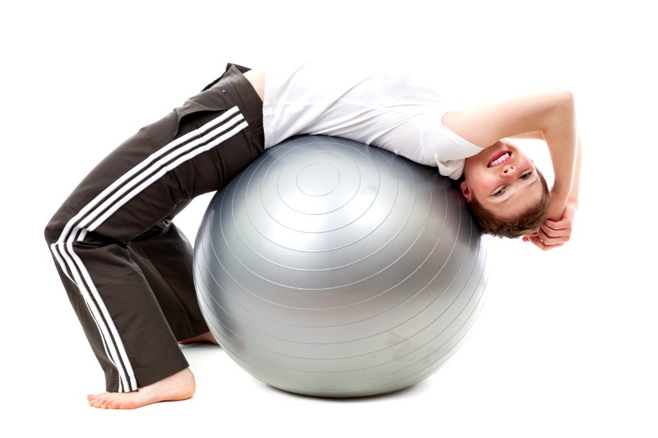 Woman In White Cap Shirt On Stability Ball