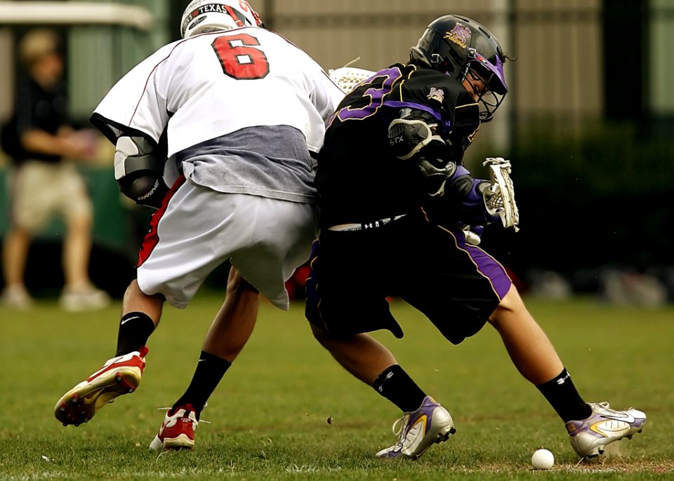 2 Men Playing Football During Daytime