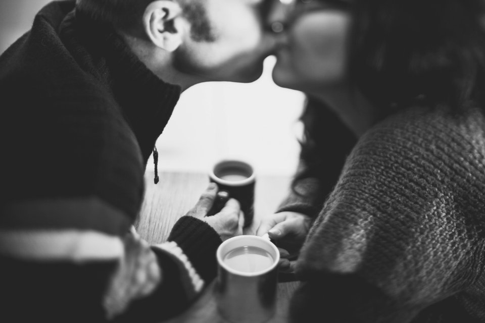 Couple Kissing With Coffee photo