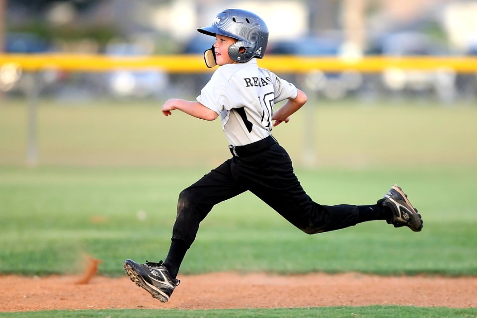 Baseball Player In Gray And Black Uniform Running