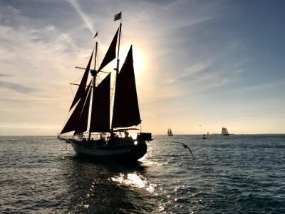 Sailboat In Open Sea At Sunset photo